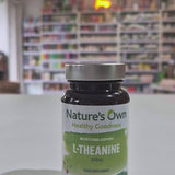 A bottle of Nature's Own L-Theanine, a nutritional supplement intended to support relaxation and brain function in a shop. 