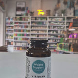 Brown supplement bottle labeled 'Weight Support Complex' by Viridian in a shop background. 