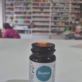 Bottle of Viridian Biotin on a white surface with a blurred store interior in the background video