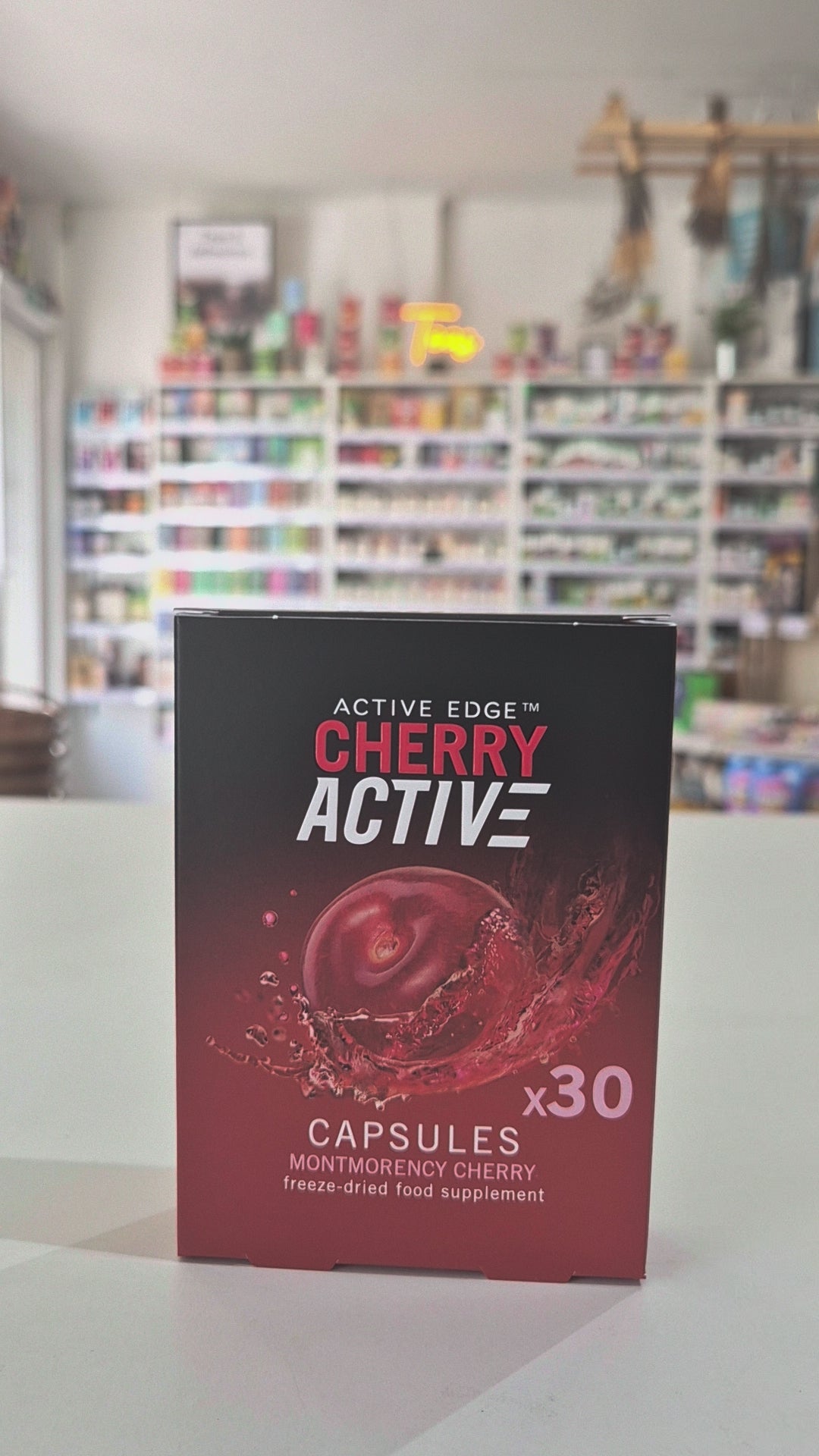 Red and black Montmorency Cherry supplement container with 'CherryActive' branding in a store setting
