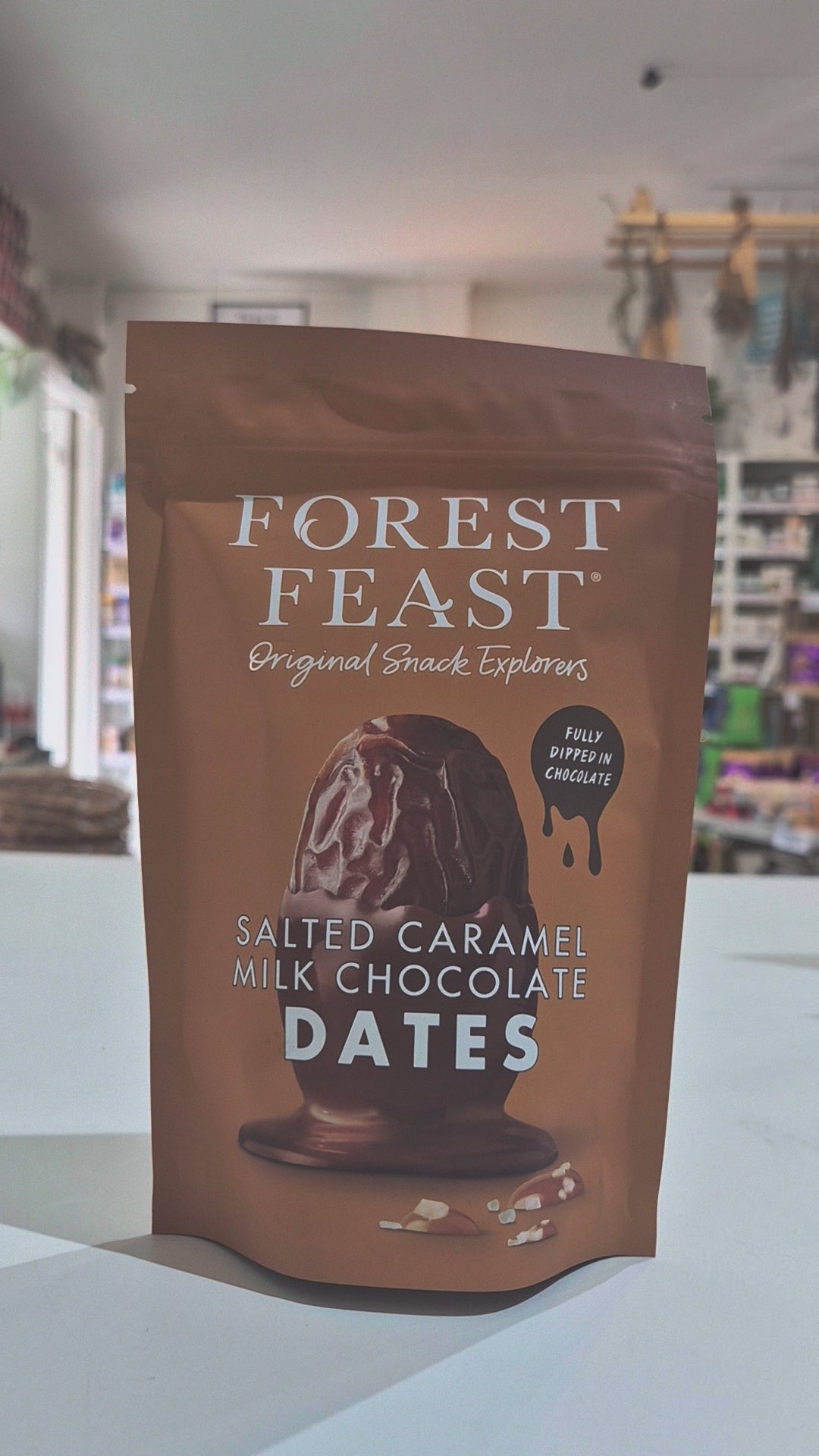 Bag of Forest Feast salted caramel milk chocolate dates on a neutral background