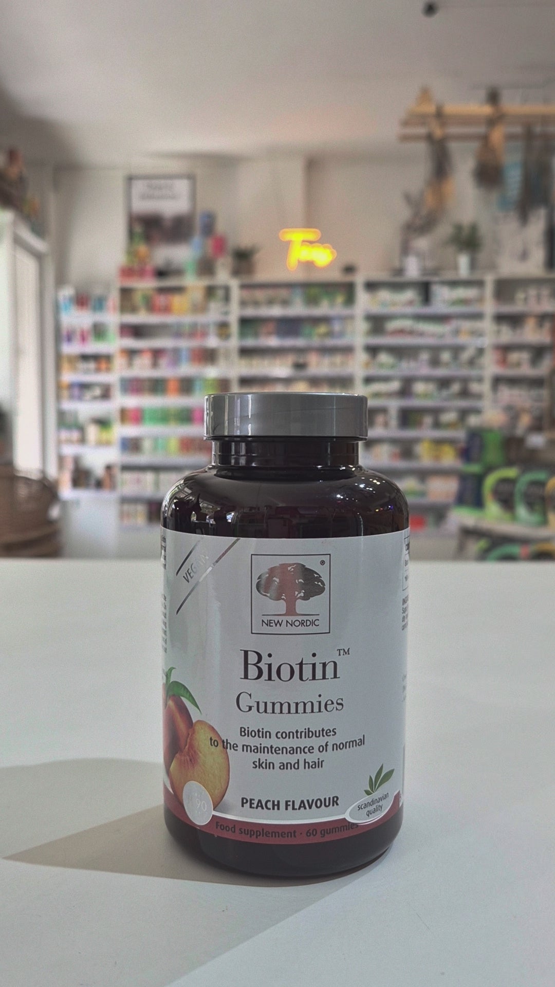 Bottle of New Nordic Biotin Gummies with peach flavor label on a counter video