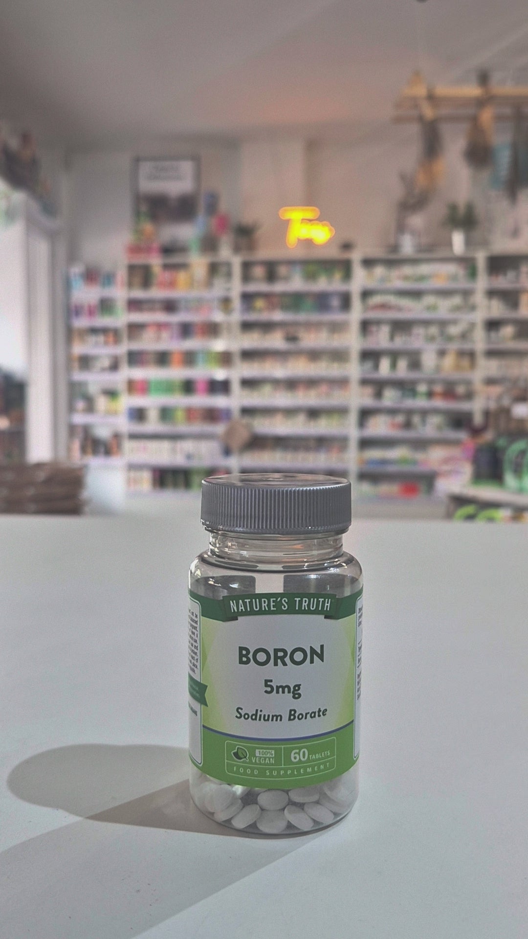 Supplement bottle labeled 'Boron 5mg Sodium Borate' by 'Nature's Truth' on a counter video.