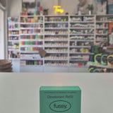 Fussy deodorant refill packaging on a counter with a store shelf in the background
