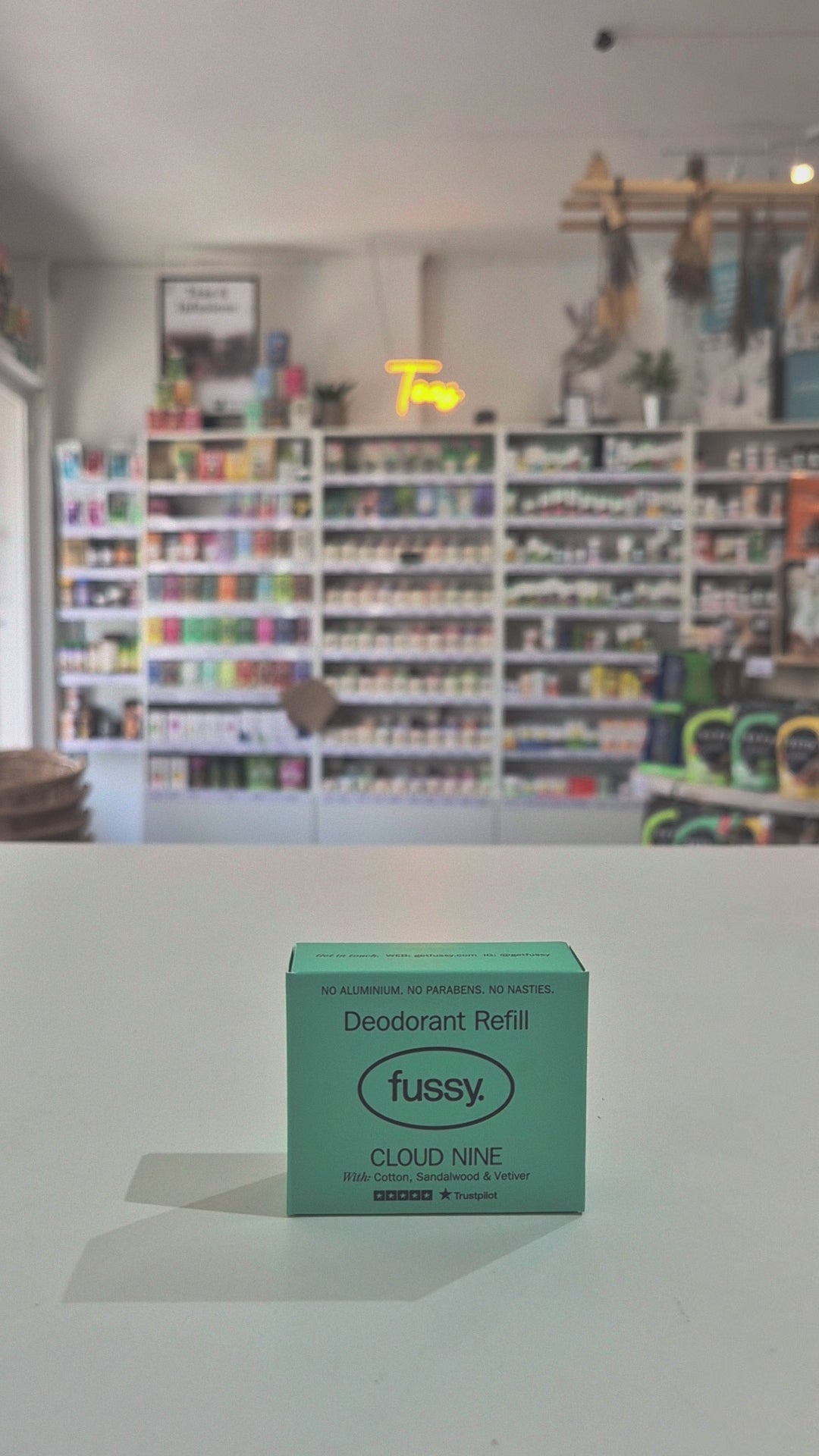 Fussy deodorant refill packaging on a counter with a store shelf in the background