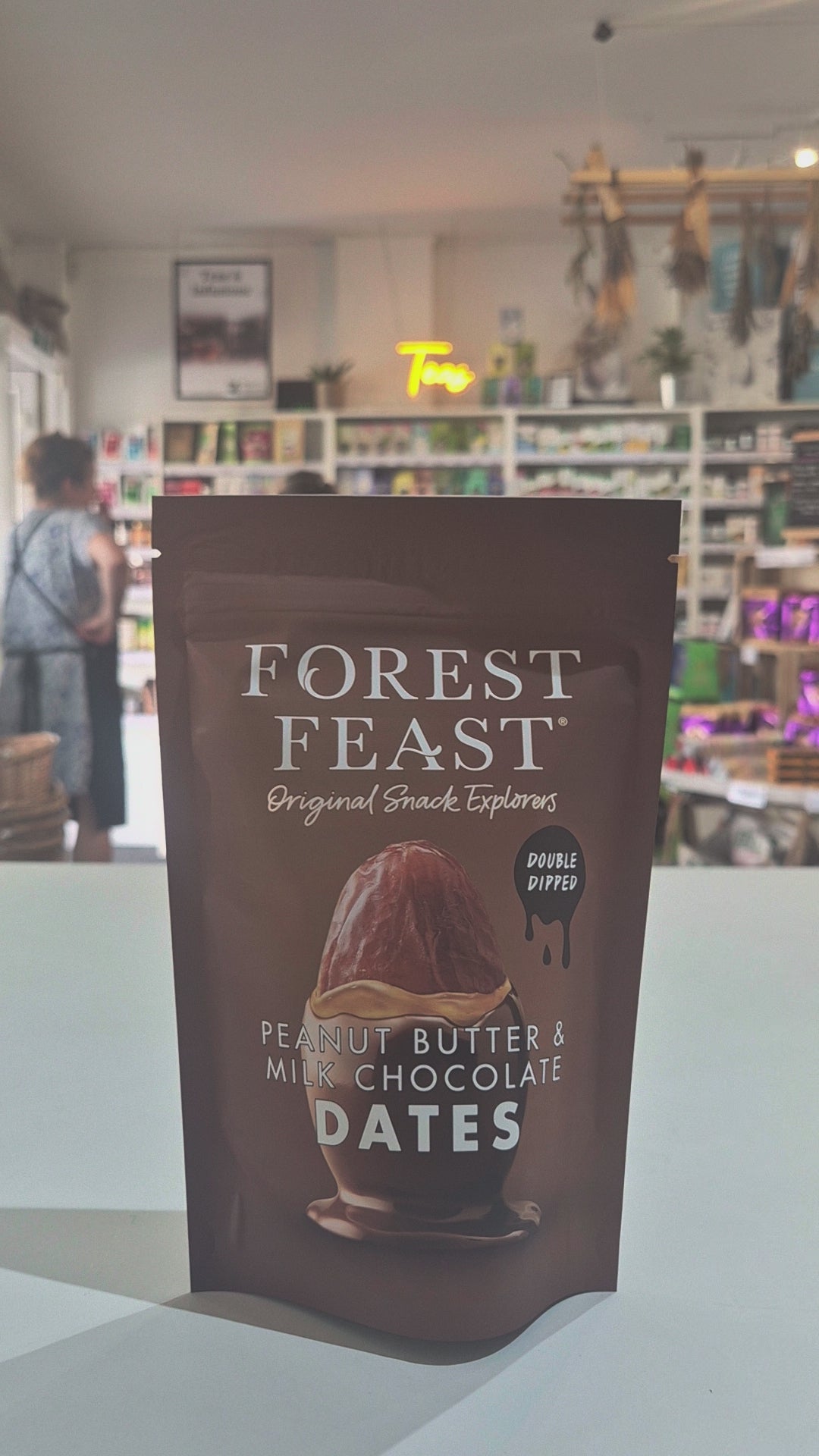 Packaged snack with 'Forest Feast' branding on a counter in a store.