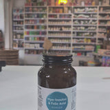 Myo-Inositol & Folic supplement bottle with Viridian label on a white surface, with shop background