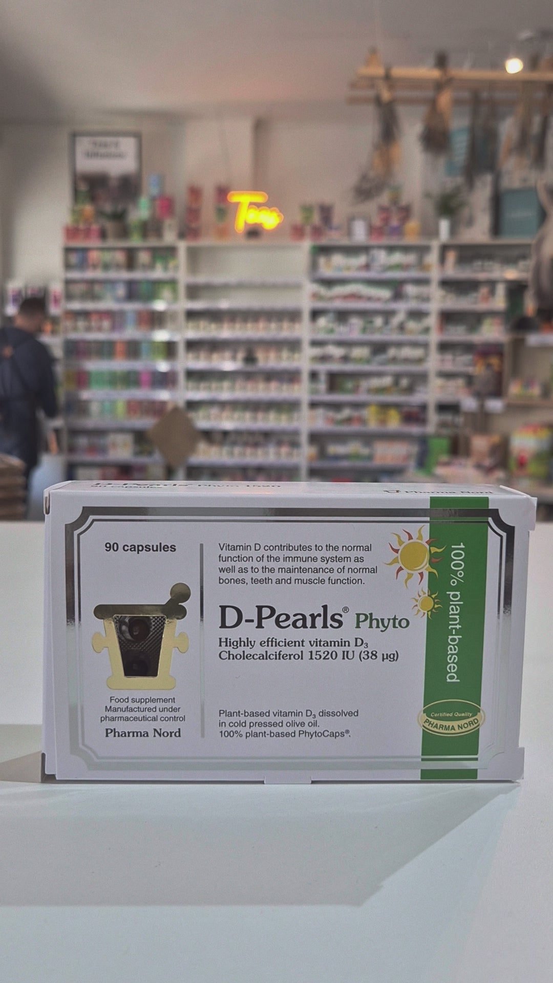 Box of D-Pearls Phyto vitamin supplement on a shelf in a pharmacy.