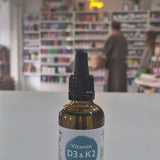 Bottle of Viridian Vitamin D3 & K2 Liquid on a table with a blurred store background as a video. 