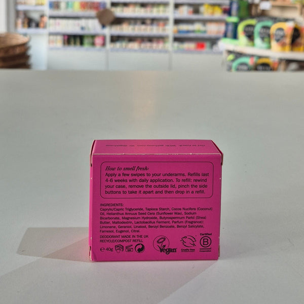 Pink box with text on a white surface in a store setting