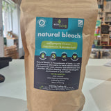 Bag of natural bleach with a label on a white surface
