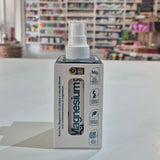Magnesium oil spray bottle packaging on a table with a blurred store background