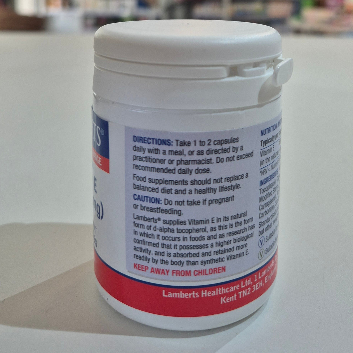 White supplement container with label on a light gray background