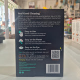 Back cover of a pack of large rubber gloves with text and QR code on a blurred indoor background