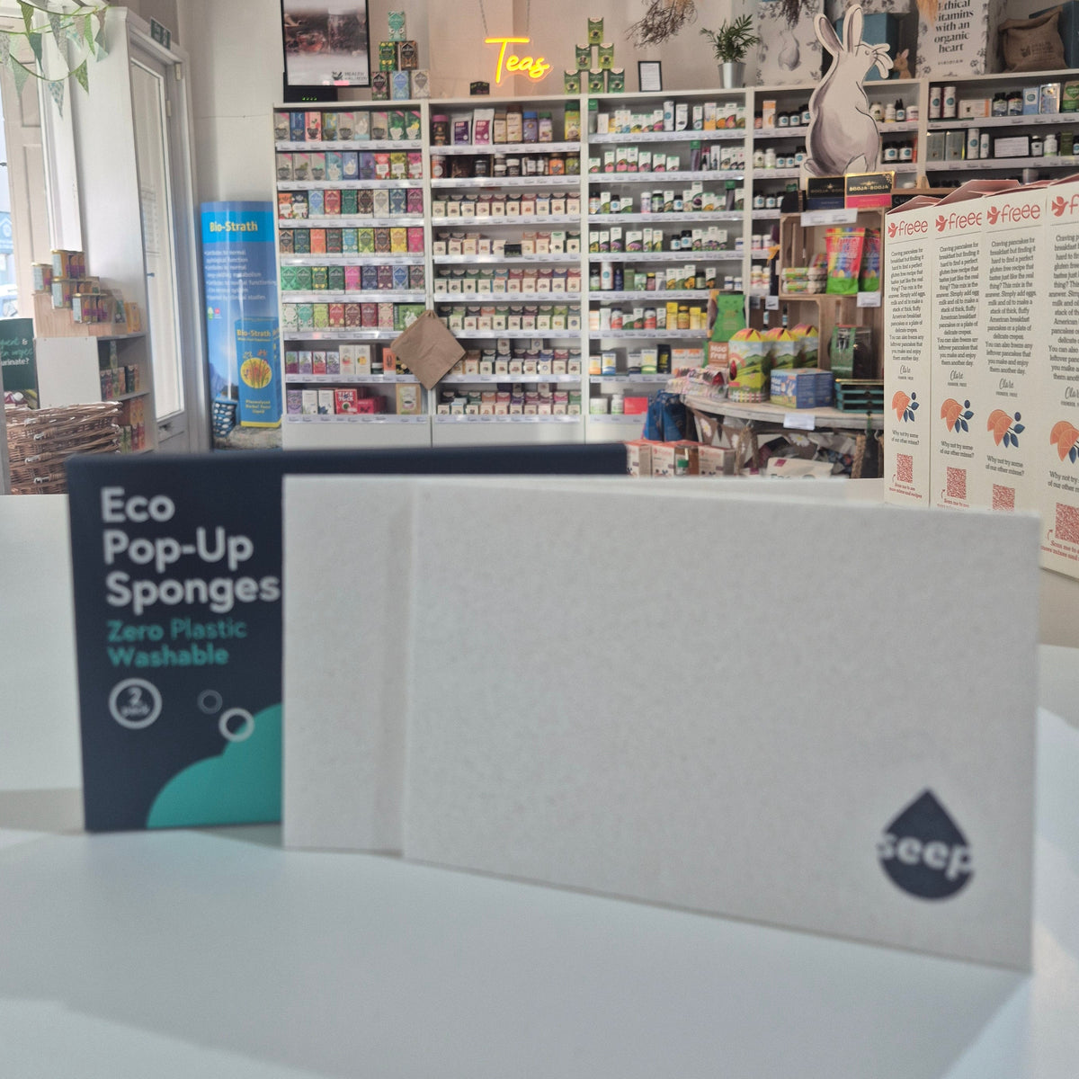 Display of eco-friendly products with a focus on a box labeled 'Eco Pop-Ups' in a store setting.