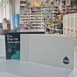 Display of eco-friendly products with a focus on a box labeled 'Eco Pop-Ups' in a store setting.