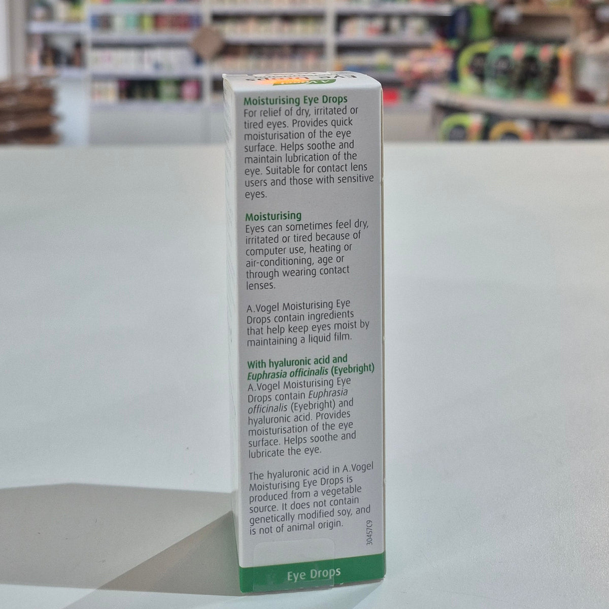 Box of eye drops with text on a surface in a store setting