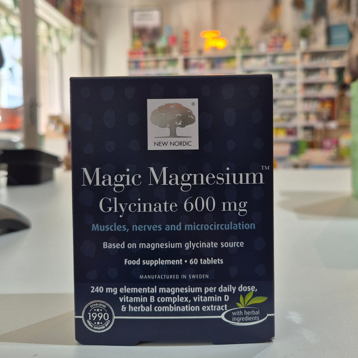 Box of New Nordic Magic Magnesium Glycinate 600 mg supplement on a blurred store shelf background
