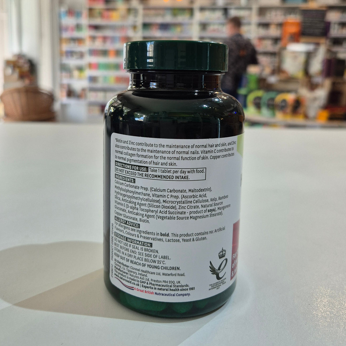 Supplement bottle with label on a counter in a store setting