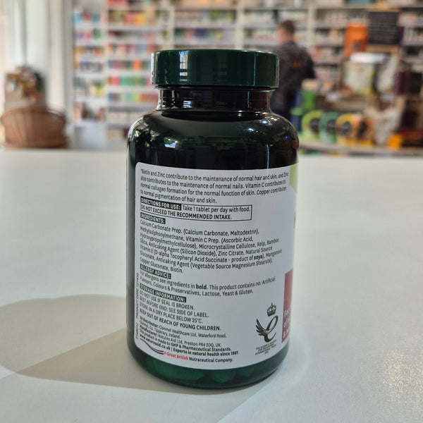 Supplement bottle with label on a counter in a store setting