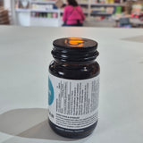 Bottle of Viridian Biotin on a white surface with a blurred store interior in the background. Black supplement bottle with a white label on a light surface, blurred background