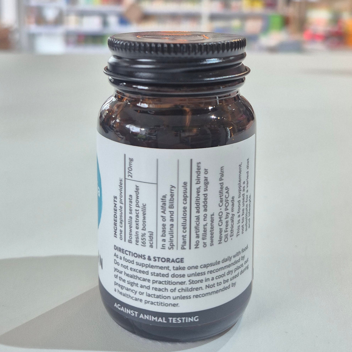 Bottle of Viridian Boswellia on a white surface with a blurred background