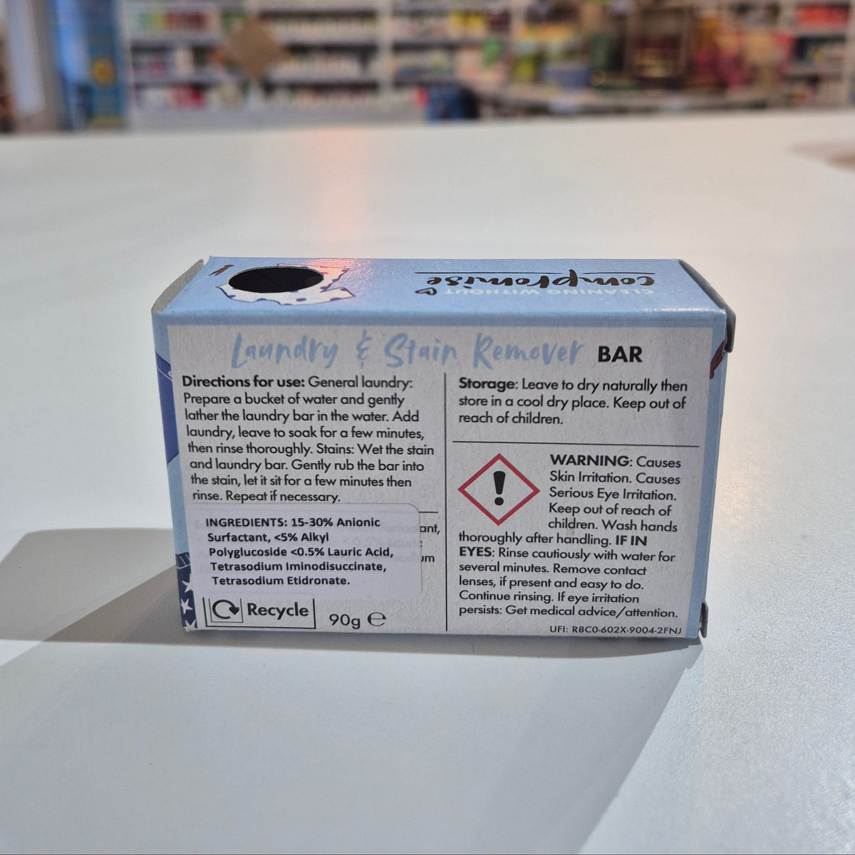 Box of a product with warning labels on a white wall