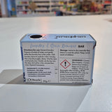 Box of a product with warning labels on a white wall