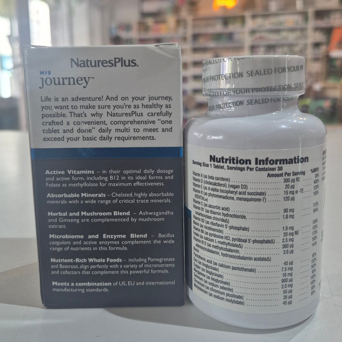 NaturesPlus supplement bottle and packaging on a white surface with a blurred background