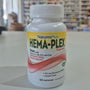 NaturesPlus Hema-Plex supplement bottle on a table with a blurred store background