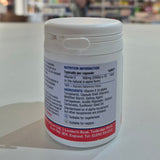 White supplement container with nutrition information label on a blurred background