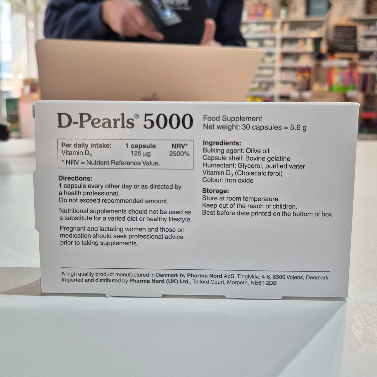Box of D-Pearls 5000 nutritional supplement with details on a counter.