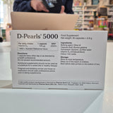 Box of D-Pearls 5000 nutritional supplement with details on a counter.