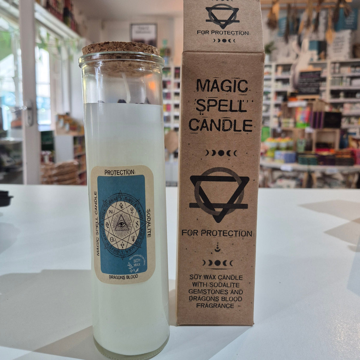 Magic spell candle with label on a white surface