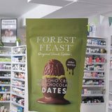 Green package of Forest Feast pistachio crisp milk chocolate dates in a store setting