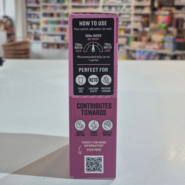 Close-up of a purple product box with text and QR code on a blurred store interior background