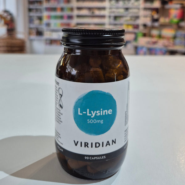 Bottle of Viridian L-Lysine supplement on a white surface with a blurred background