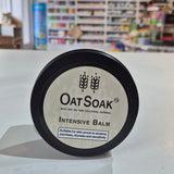 OatSoak Intensive Balm container on a white surface with a blurred store background