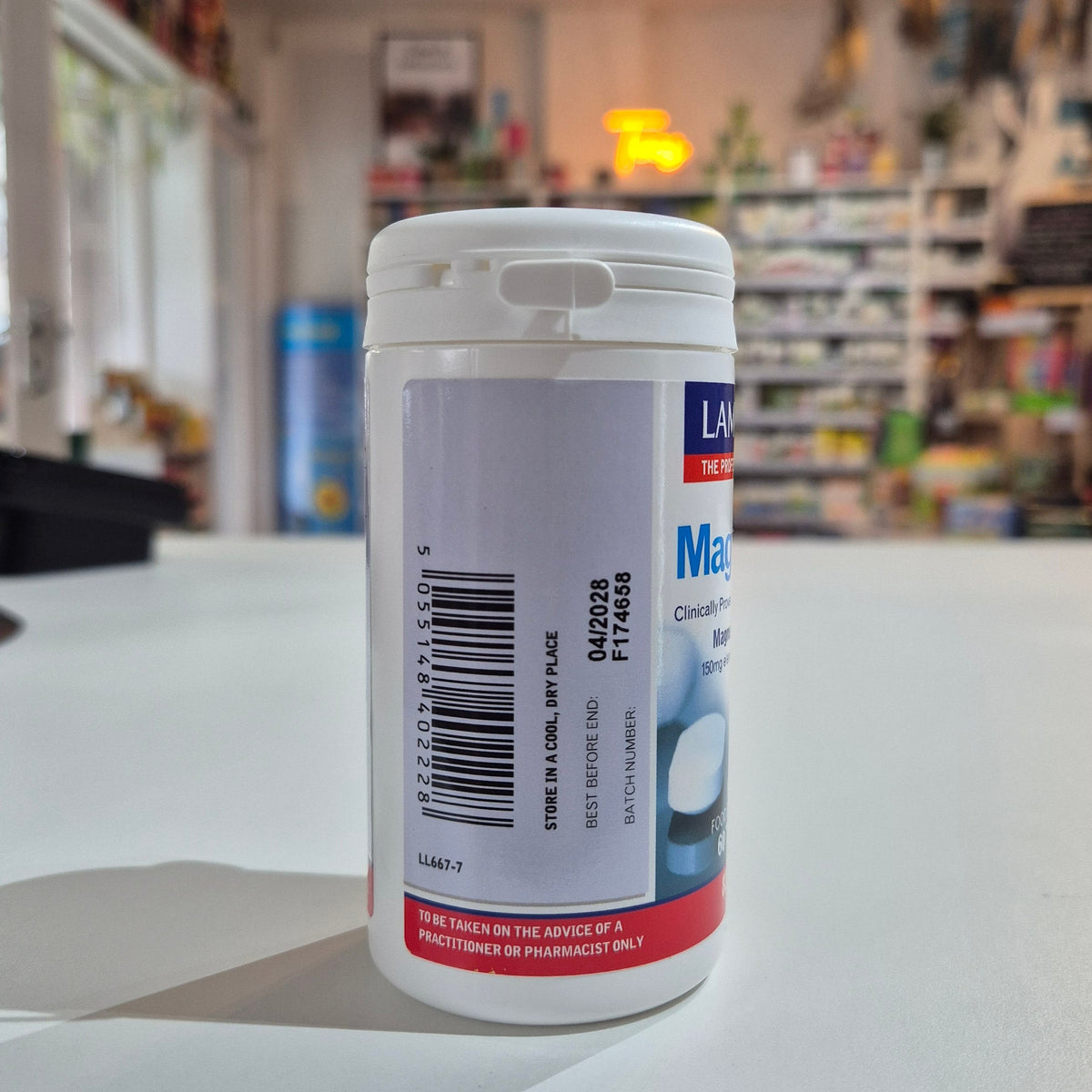 Lamberts MagAsorb supplement container with label on a counter in a store setting