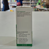 Back of a supplement bottle label with product details on a blurred store background