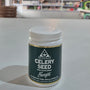 Jar of Bio-Health celery seed supplement on a table with a blurred background