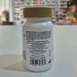 Supplement bottle with label on a white surface, blurred store background
