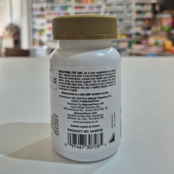 Supplement bottle with label on a white surface, blurred store background
