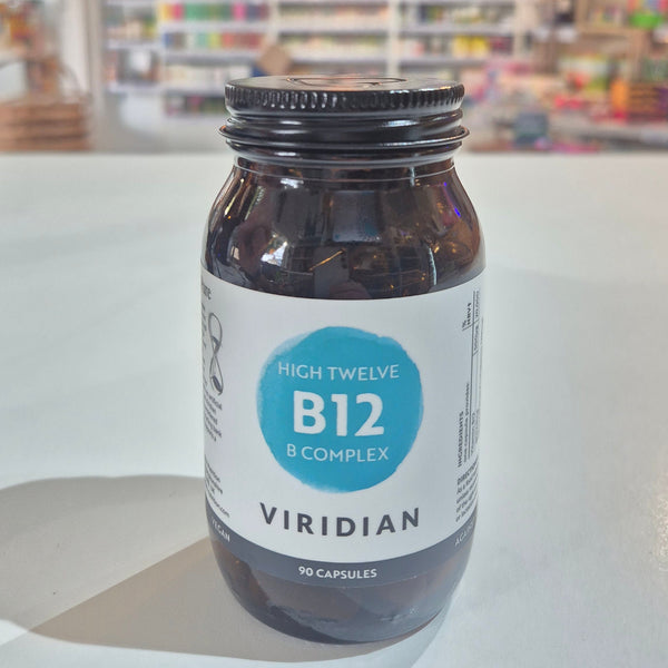 Jar of Viridian High Twelve B12 B Complex supplement on a white surface with a blurred store background.