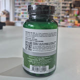 Green supplement bottle with label and QR code on a blurred store background