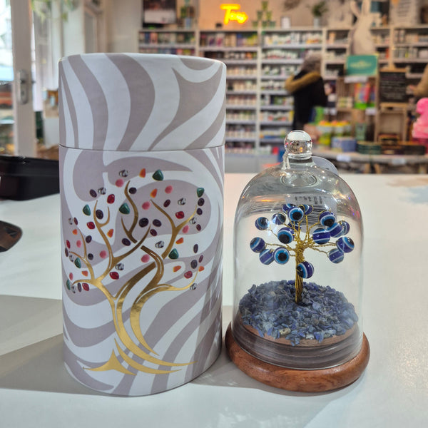 Decorative stone tree with intricate design and colourful elements in a store setting