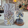 Decorative stone tree with intricate design and colourful elements in a store setting