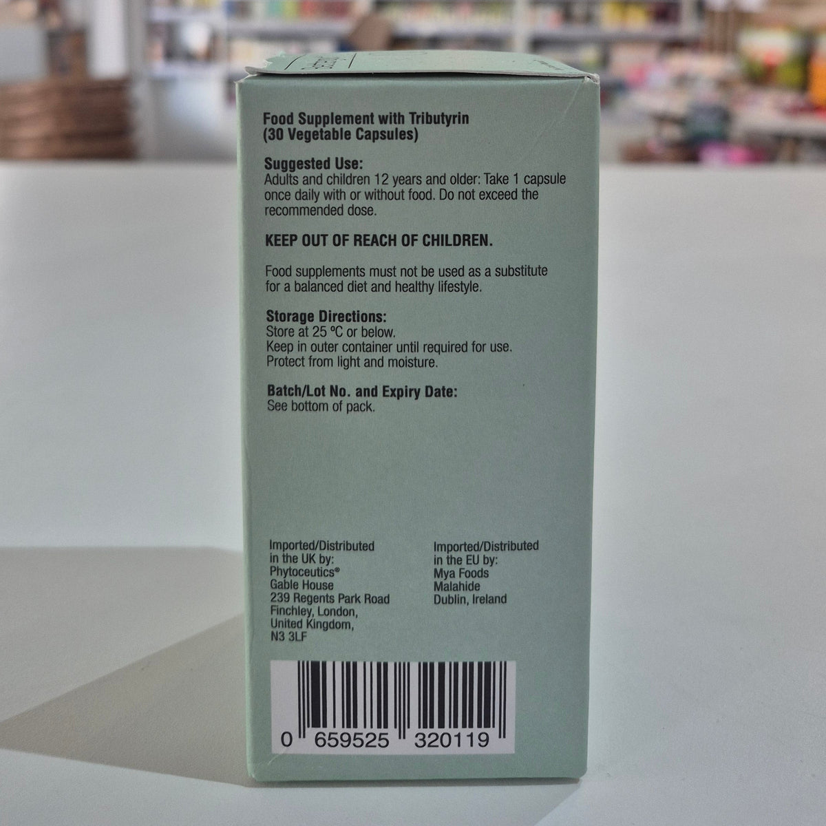 Back of a supplement packaging with text and bar code on a light background
