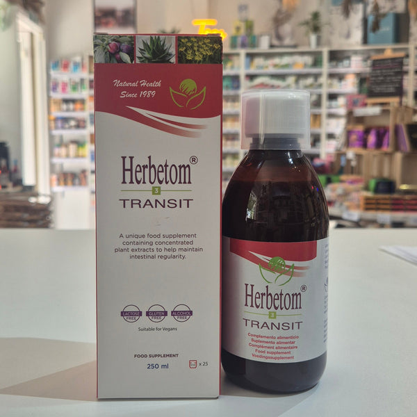 A bottle of Herbetom Transit herbal supplement and its matching cardboard box, displayed on a white shelf in a blurred retail store setting.