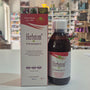 A bottle of Herbetom Transit herbal supplement and its matching cardboard box, displayed on a white shelf in a blurred retail store setting.